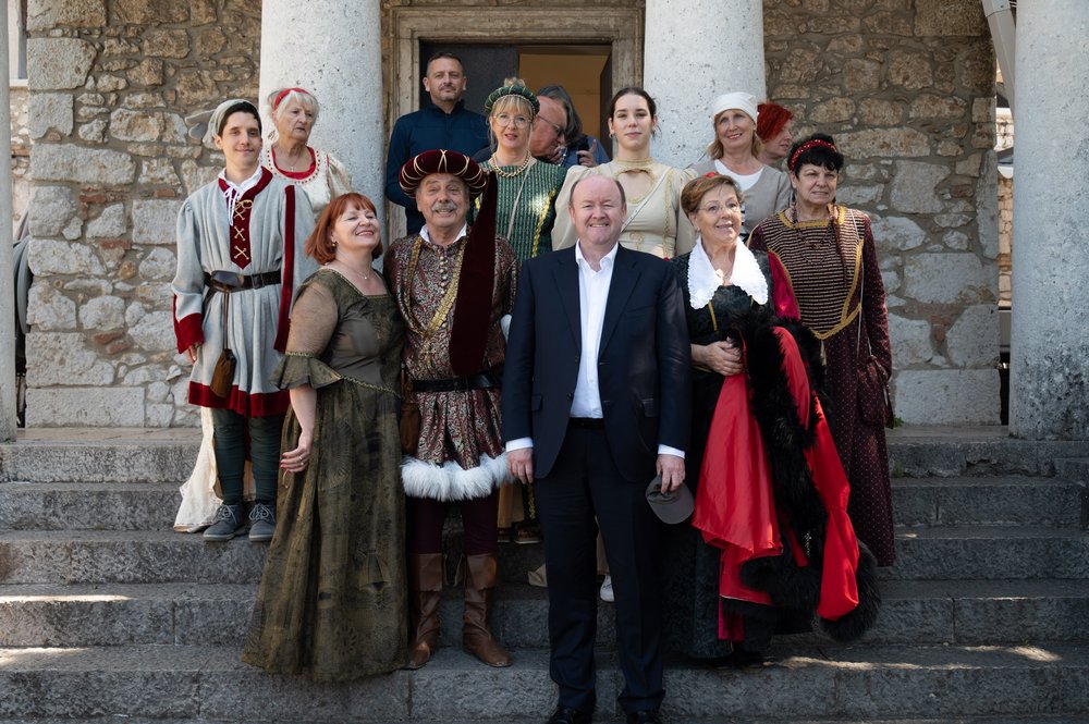A group on a walking tour, dressed in old-time costume