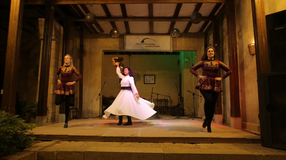 Woman dancing with large circle skirt flowing around her on stage