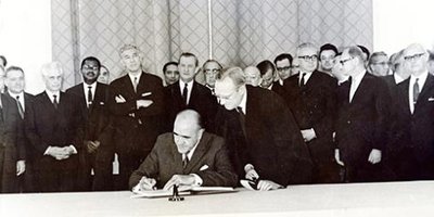A group of men witnessing the signing of the nuclear non-proliferation treaty.