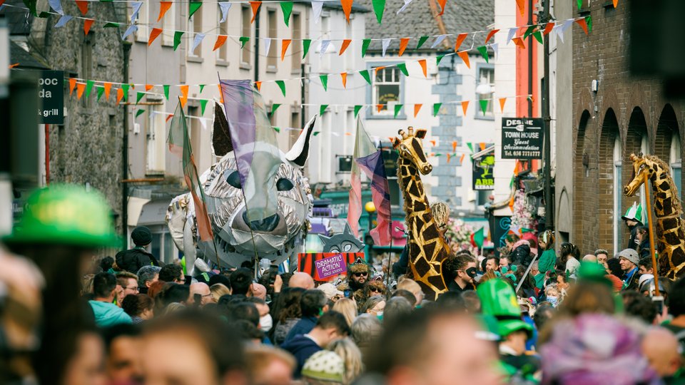 st patrick's day parade with people in colourful costume