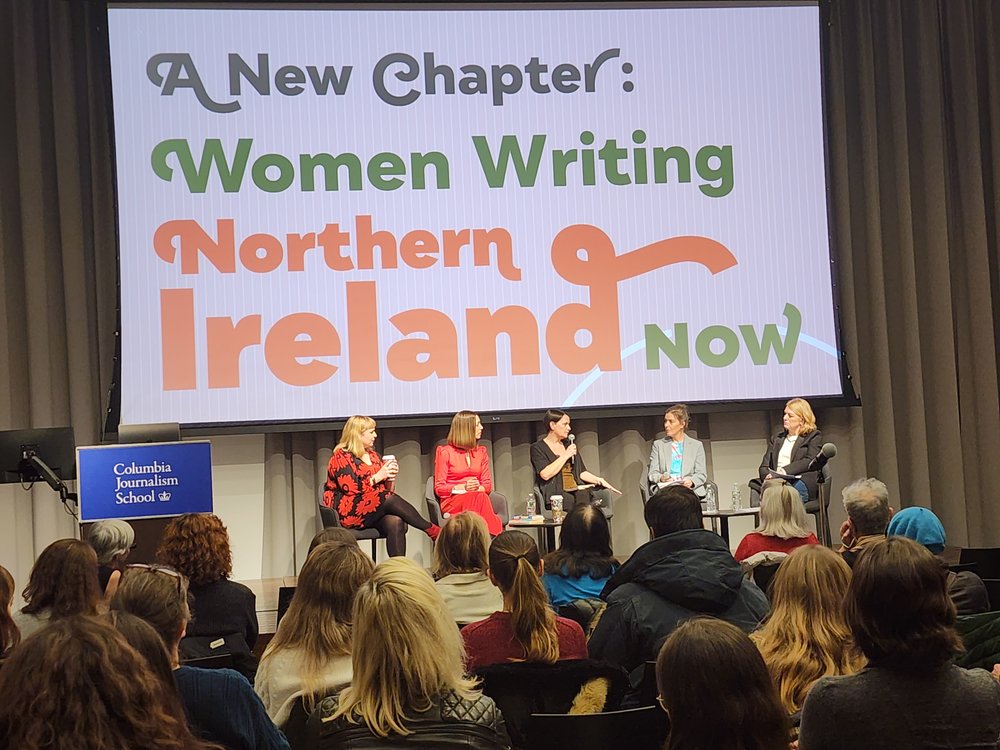 Three authors and two panelists on stage at the Columbia University event