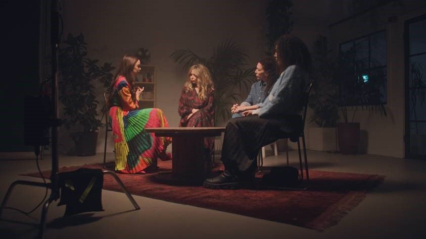 Four creatives sitting in a circle discussing creativity.