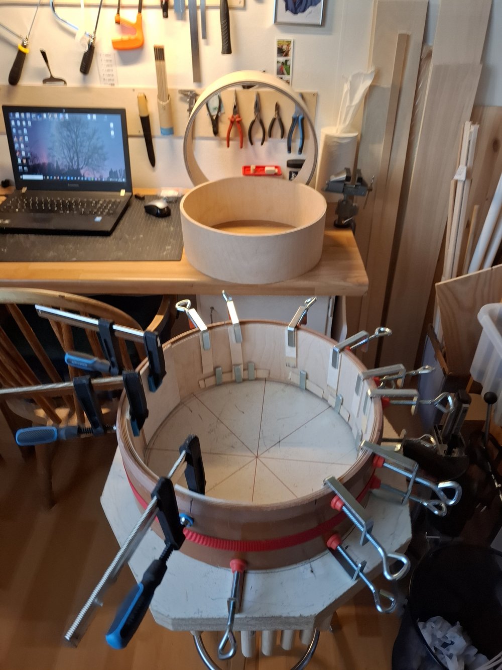 Skin being stretched over the top of a bodhrán.