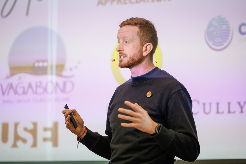 James McManus speaking on stage