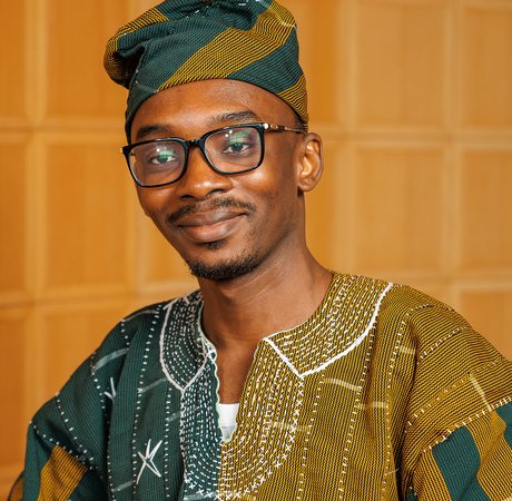 Man smiling wearing traditional Ghanaian attire