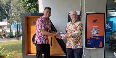 Two people exchanging books