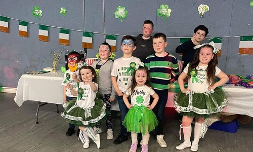 A group of children dressed in St Patrick's Day themed clothing
