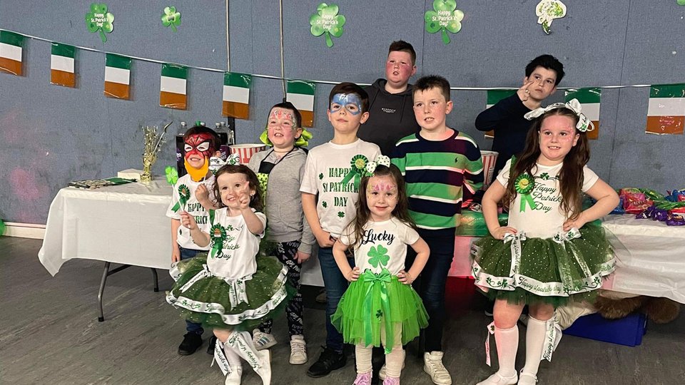 A group of children dressed in St Patrick's Day themed clothing