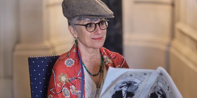 Woman reading a newspaper in the Embassy