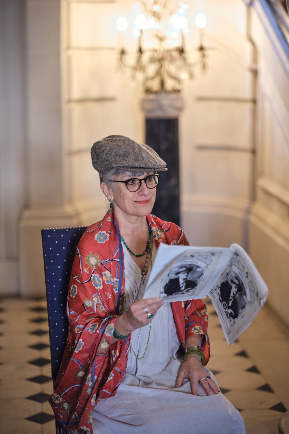 Woman reading a newspaper in the Embassy