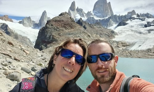 A couple's selfie in front of a glacier