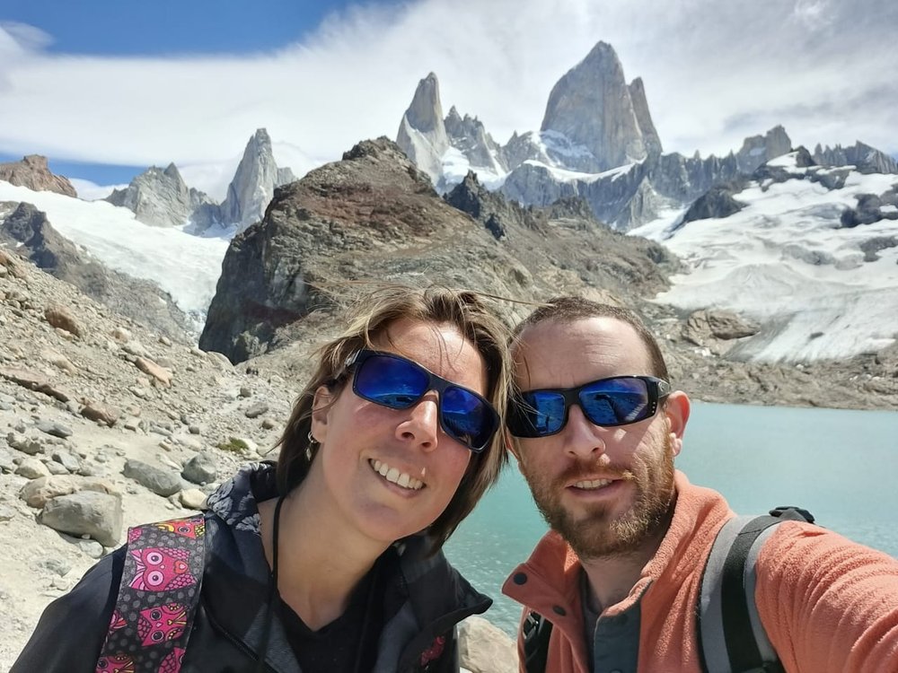 A couple's selfie in front of a glacier