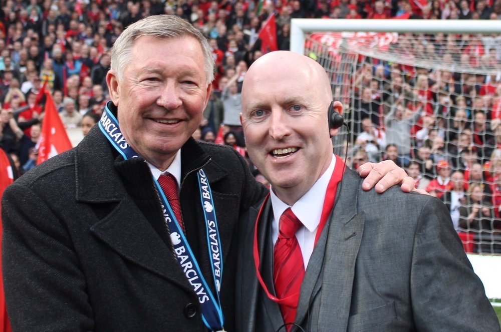 Man standing with Alex Furguson in a Stadium