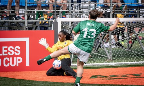 Irish player shoots football towards goal at Homeless World Cup in South Korea