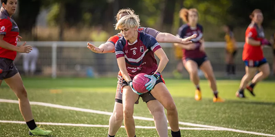 A Bordeaux player holds off a challenge at the women's finals in Nantes 2023