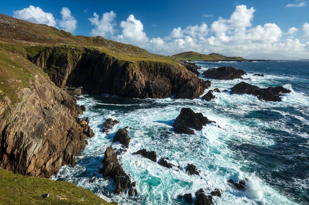 Waves crashing around rocky cliffs on Achill Island