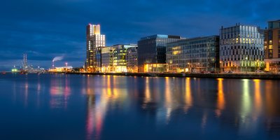 Dublin's docklands high rise buildings and river lit up at night