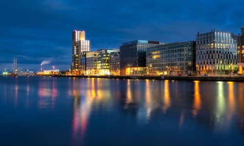 Dublin's docklands high rise buildings and river lit up at night