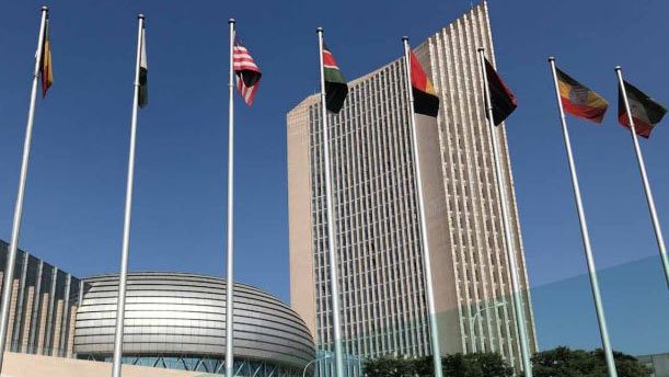 flags in front of large office blocks