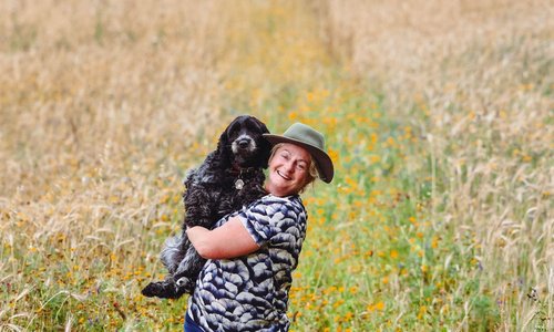 Ailbhe Gerrard gives her dog a hug in a field