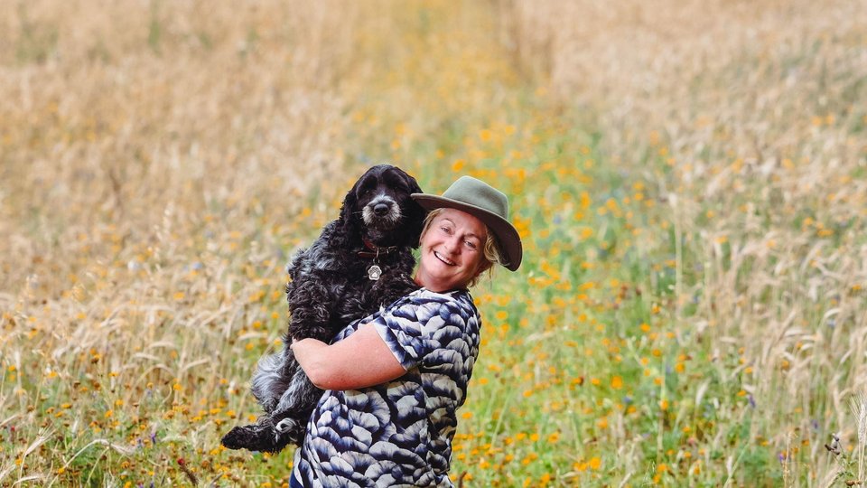 Ailbhe Gerrard gives her dog a hug in a field