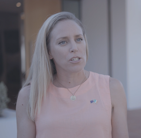 A woman speaking to a camera standing outside of the Irish ambassador's residence in Australia