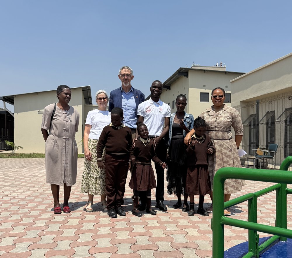 People posing for a photo in a schoolyard
