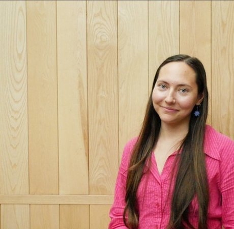 Woman in a pink blouse smiling