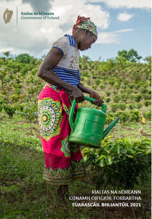 Cover of 2021 Annual Report showing a woman watering crops