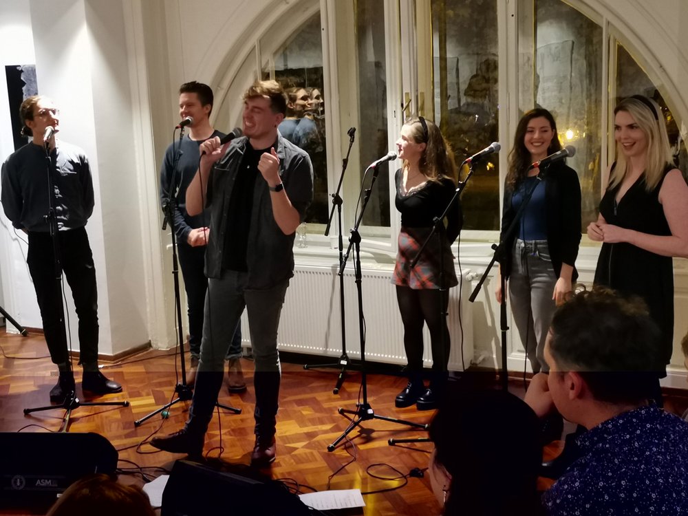 A group singing into microphones