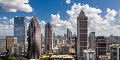 Atlanta's cityscape skyline with high rise buildings on a sunny day.