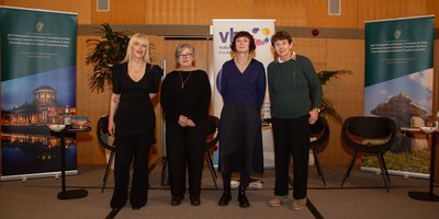 Four women authors standing on stage