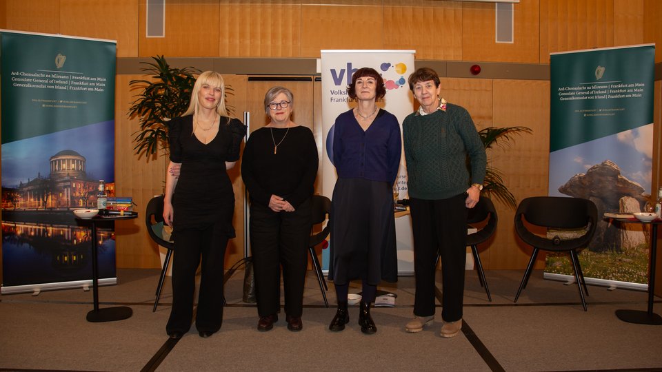 Four women authors standing on stage