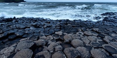 Rock formations at the Giant's Causeway, overlooking a choppy sea.