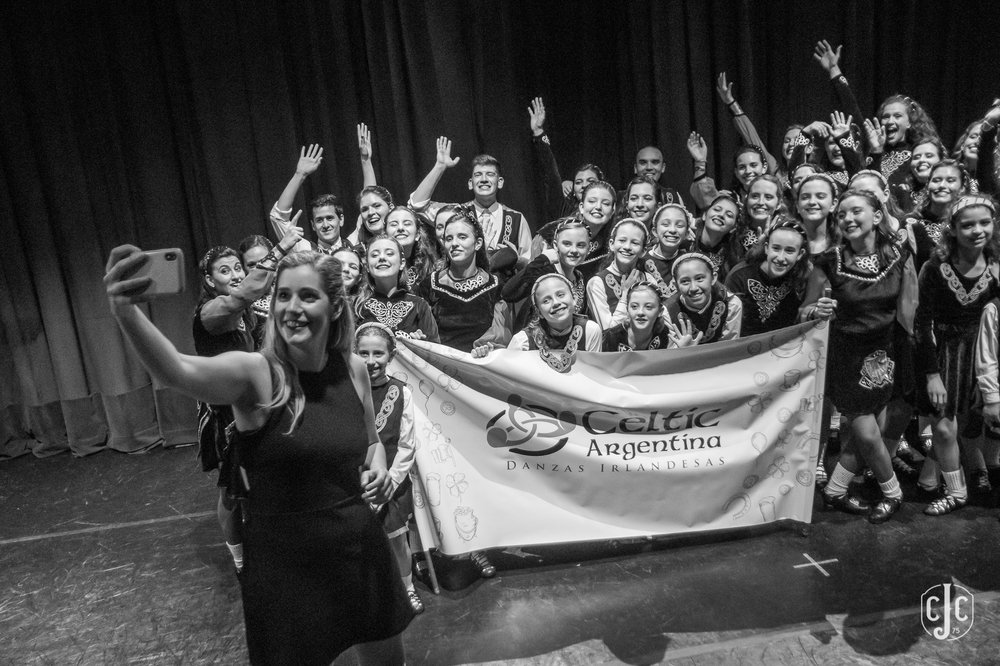 Woman taking a selfie with a dance group
