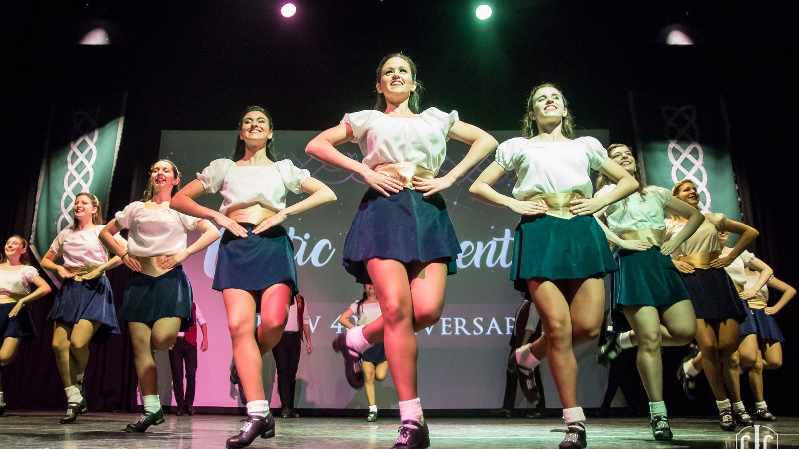 A group of Irish dancers dancing on a stage