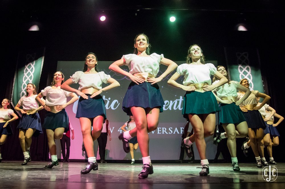 A group of Irish dancers dancing on a stage