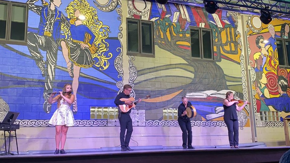 Irish musicians with graphics projected on to them