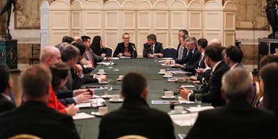 Representatives from the Department of Foreign Affairs and the Ireland-Chile Chamber of Commerce sit around a boardroom table in discussion.