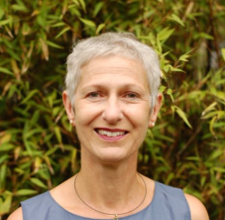 Christine O'Neill smiling in front of greenery