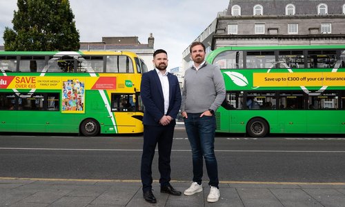 CitySwift founders Alan Farrelly and Brian O'Rourke stand together in front of two Dublin buses