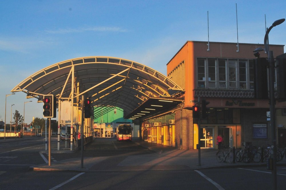 A covered depot at the Cork City bus station in golden hour sunlight