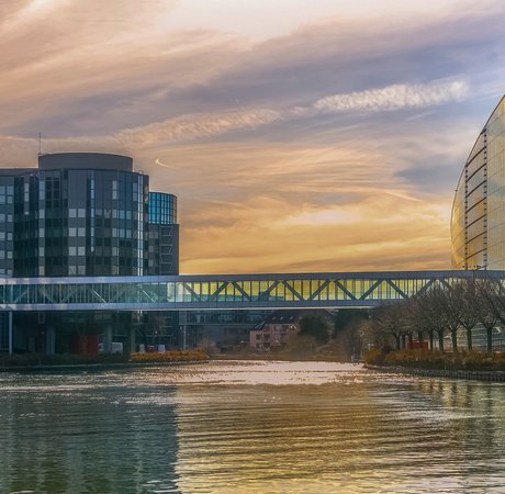 Strasbourg European Institutions (Parliament and Council) cityscape at dusk. Strasbourg skyline with Ill river and landmarks.