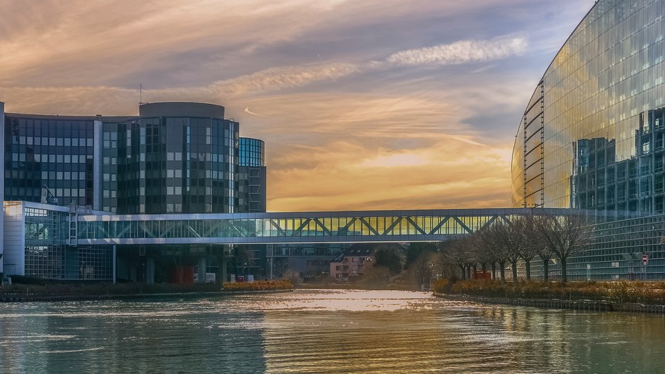 Strasbourg European Institutions (Parliament and Council) cityscape at dusk. Strasbourg skyline with Ill river and landmarks.