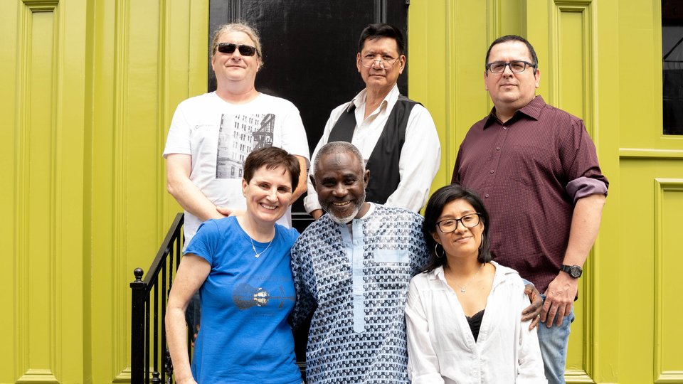 Six people standing on steps