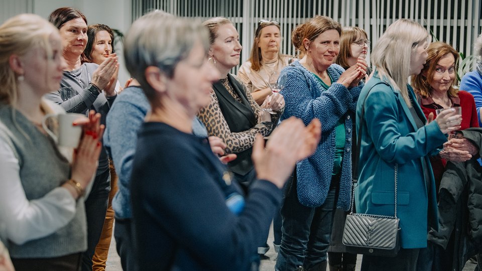 Women in the audience clapping