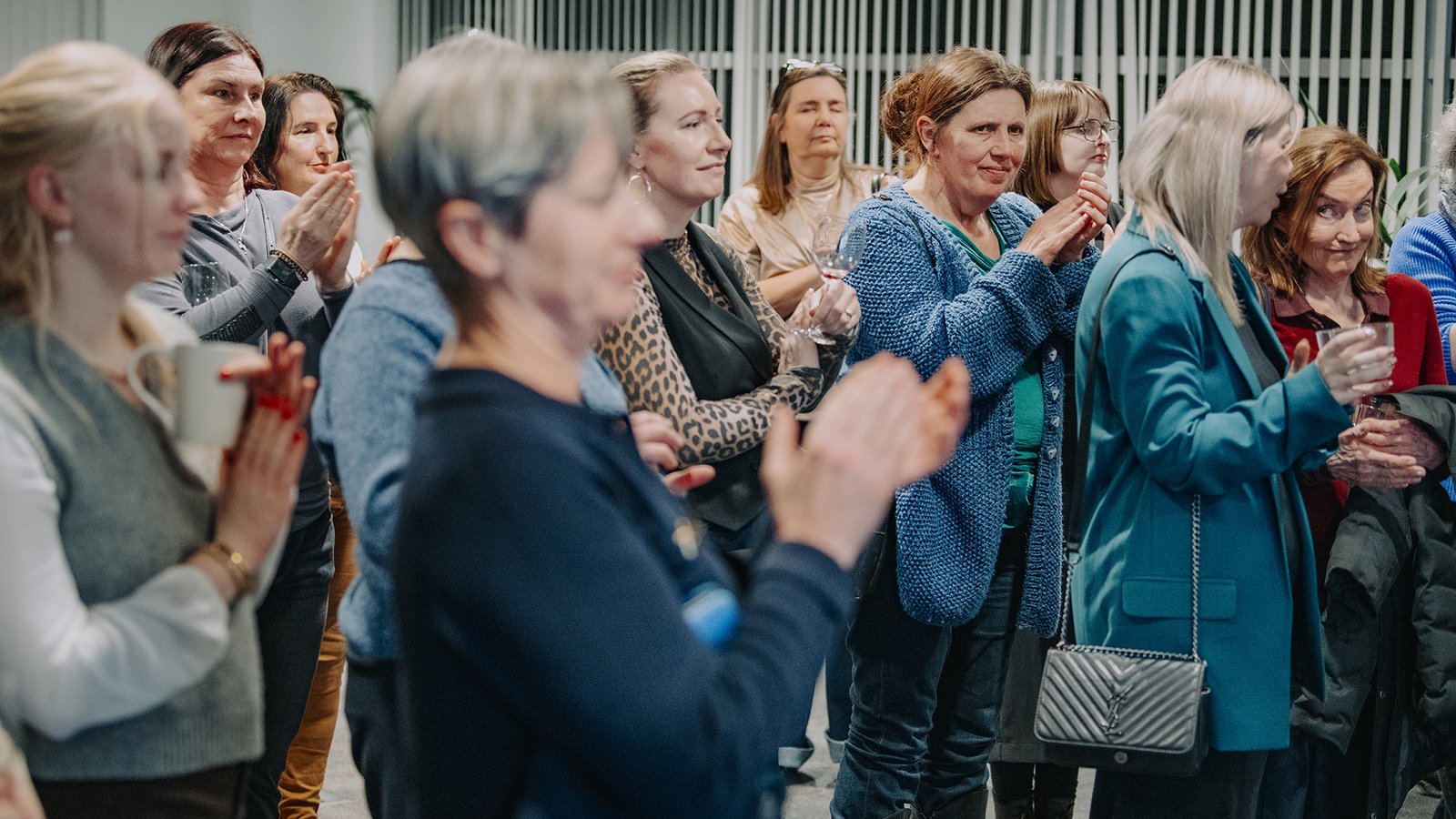 Women in the audience clapping