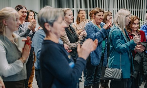 Women in the audience clapping