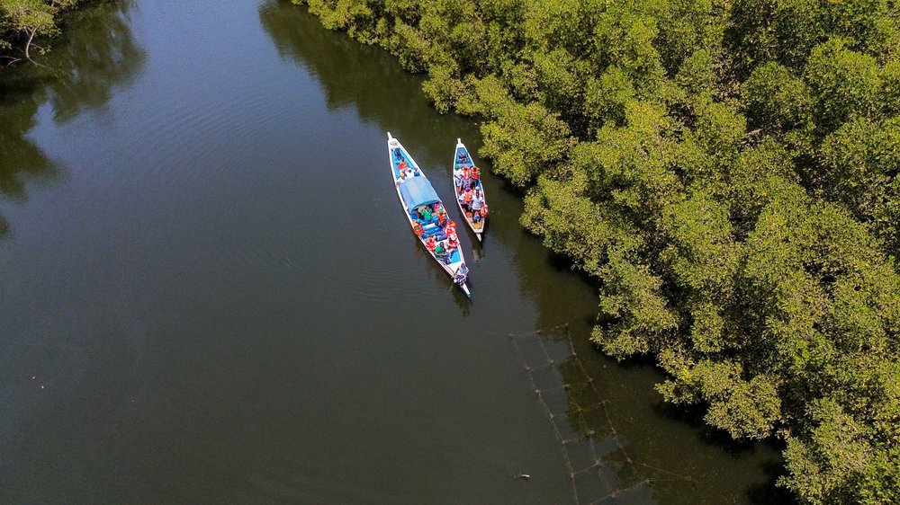 Aerial shot of boat on a river.