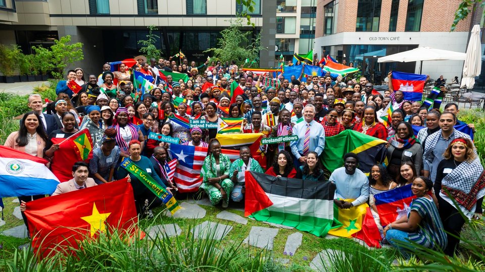 Irish fellows programme participants standing together with flags